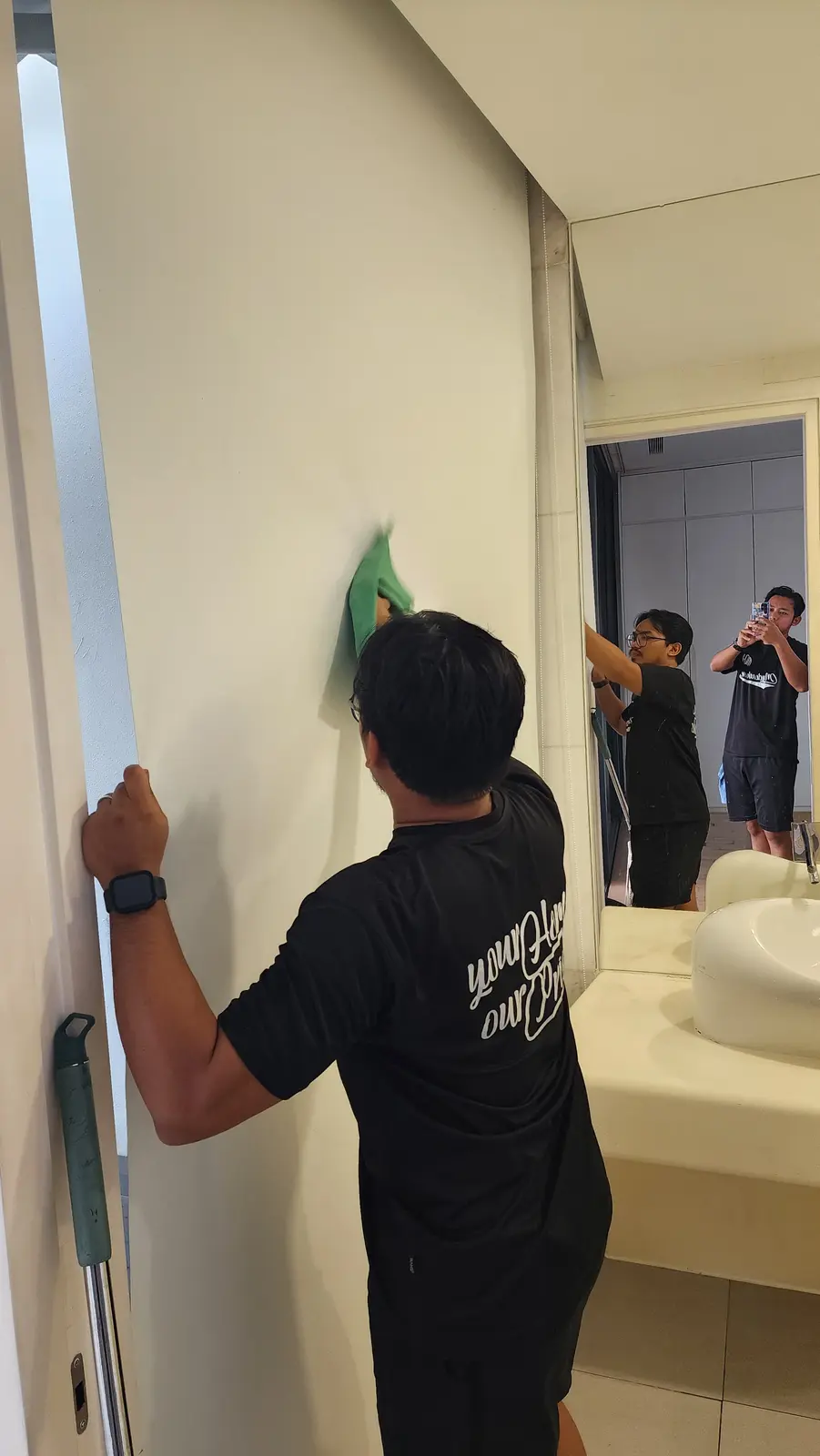 Cleaner wiping a wall after renovation