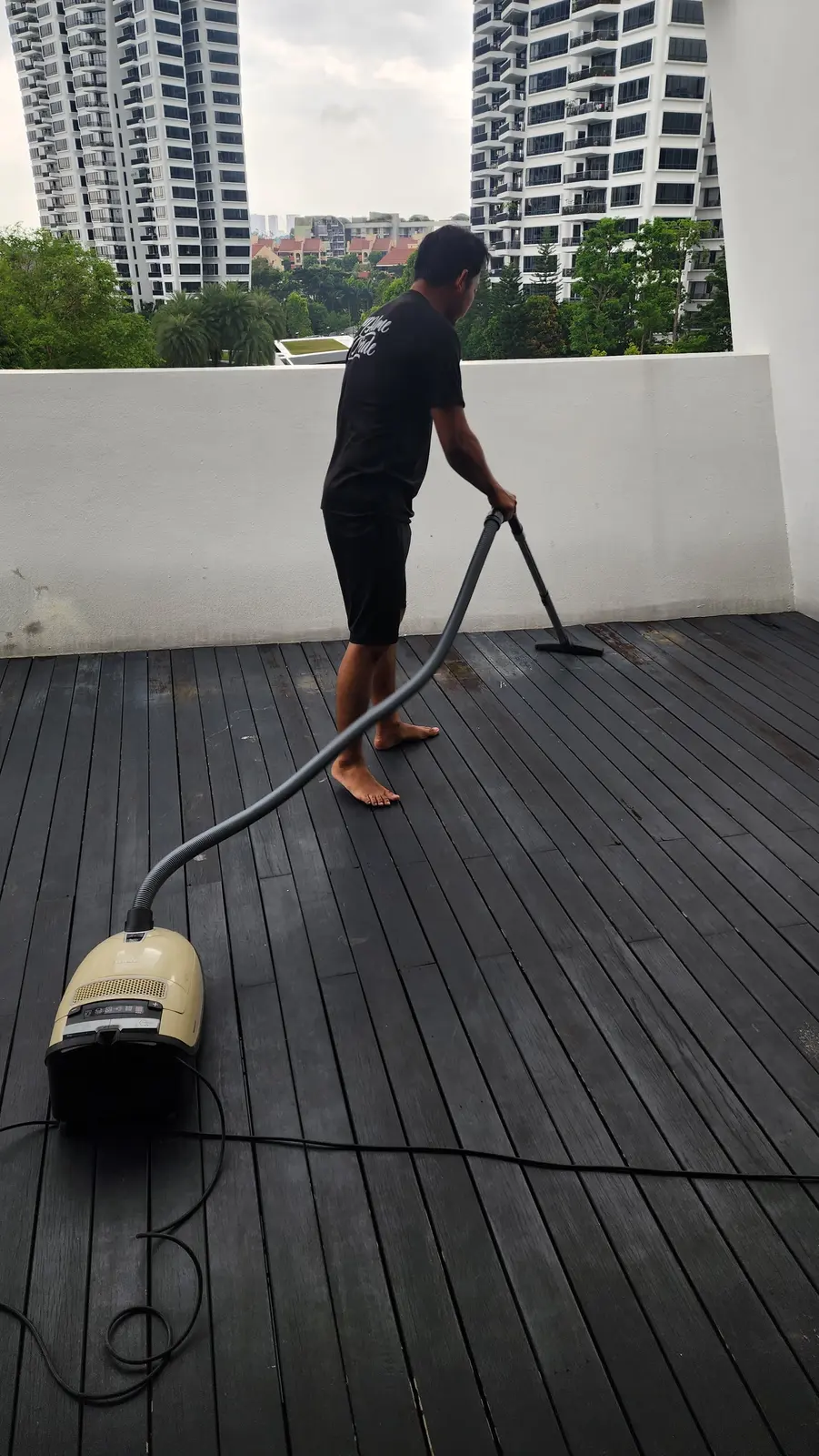 Cleaner using equipment on an outdoor deck